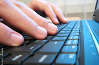computer keyboard with human hand close-up